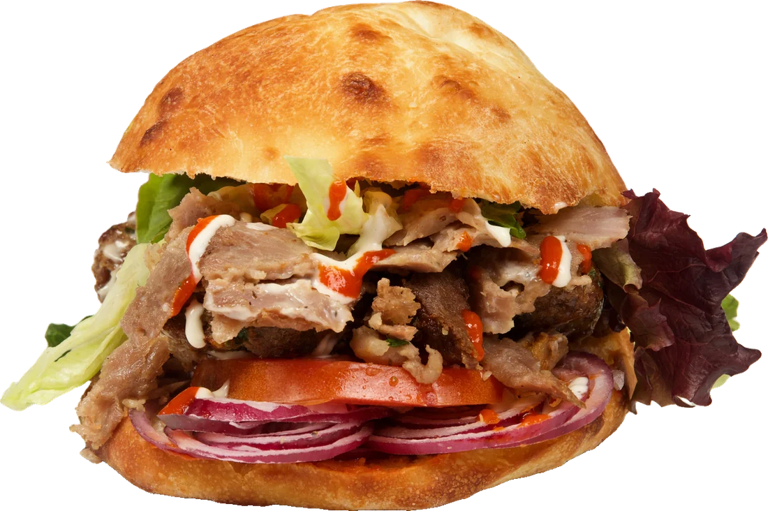 Berliner döner sandwich with lettuce, tomato and red onion in a fresh-baked bun